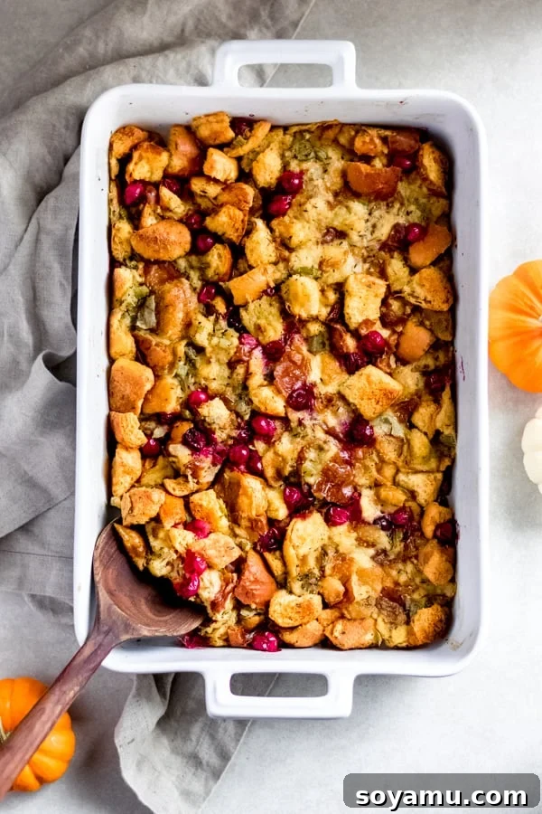 Brioche Stuffing with Cranberries Golden brown brioche stuffing with cranberries baked to perfection in a cast iron pan, ready for Thanksgiving dinner.