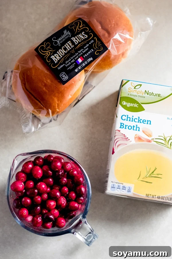 Essential Brioche Stuffing Ingredients Key ingredients for brioche stuffing: fluffy brioche buns, vibrant fresh cranberries, and savory chicken broth, all sourced from ALDI.