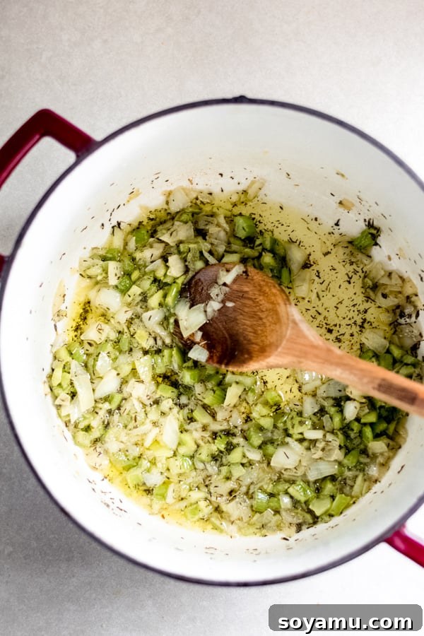 Sautéing Aromatics for Stuffing Diced onions and celery, along with herbs, gently sautéing in melted butter in a large pot, building the savory base for stuffing.