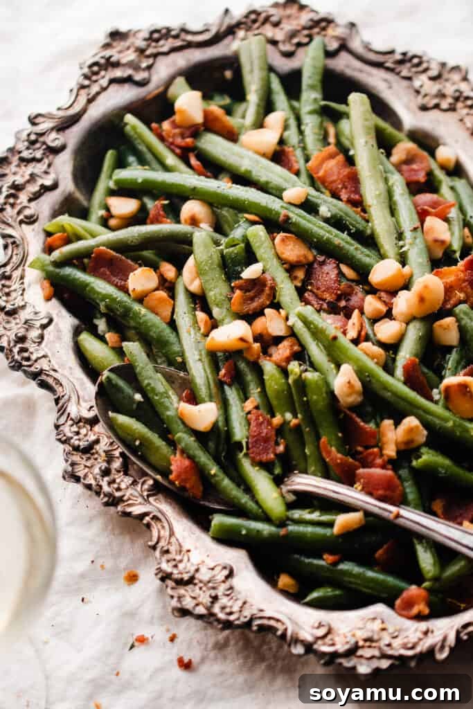 Effortless Gluten-Free Dairy-Free Bacon Green Beans 8 A close-up of a serving spoon in a dish of bacon green beans.