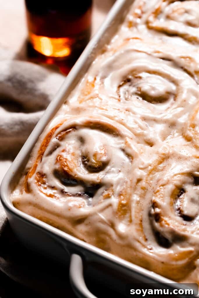 A full pan of beautifully frosted brioche cinnamon rolls, ready to be enjoyed.