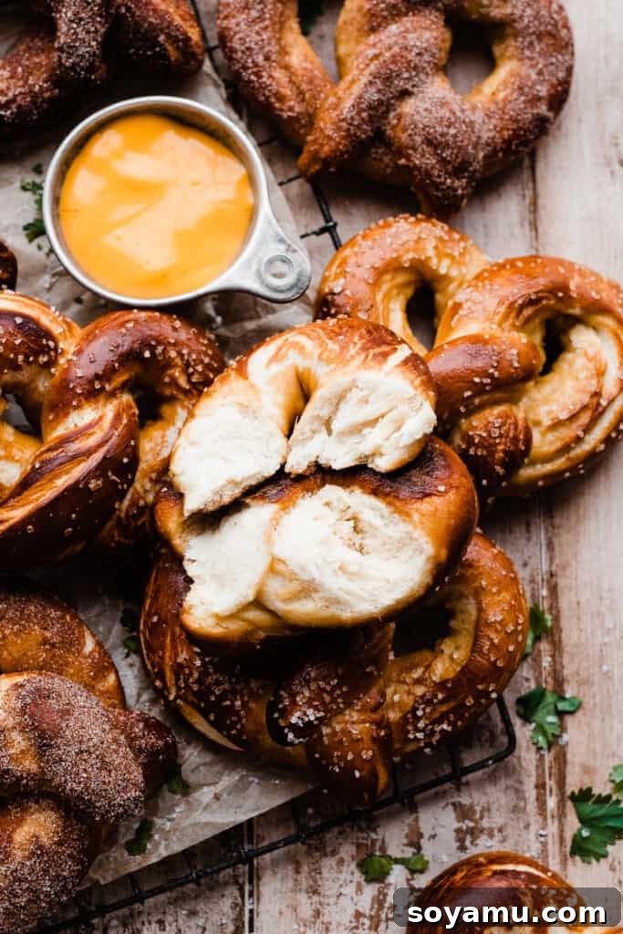 Homemade Soft Pretzel Trio 3 Soft pretzels arranged artfully on a vintage wire rack, with one pretzel gently broken open to reveal its irresistible fluffy interior.