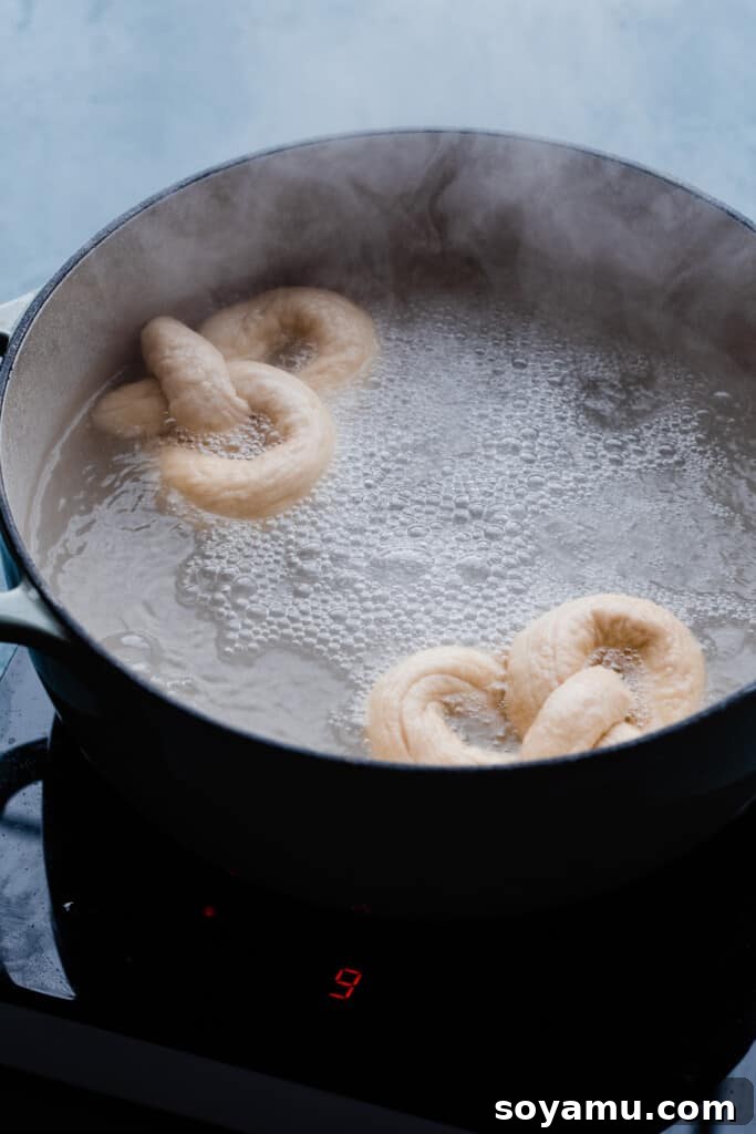 Homemade Soft Pretzel Trio 8 The twisted dough submerged in a hot baking soda bath, undergoing the crucial flavor development stage.