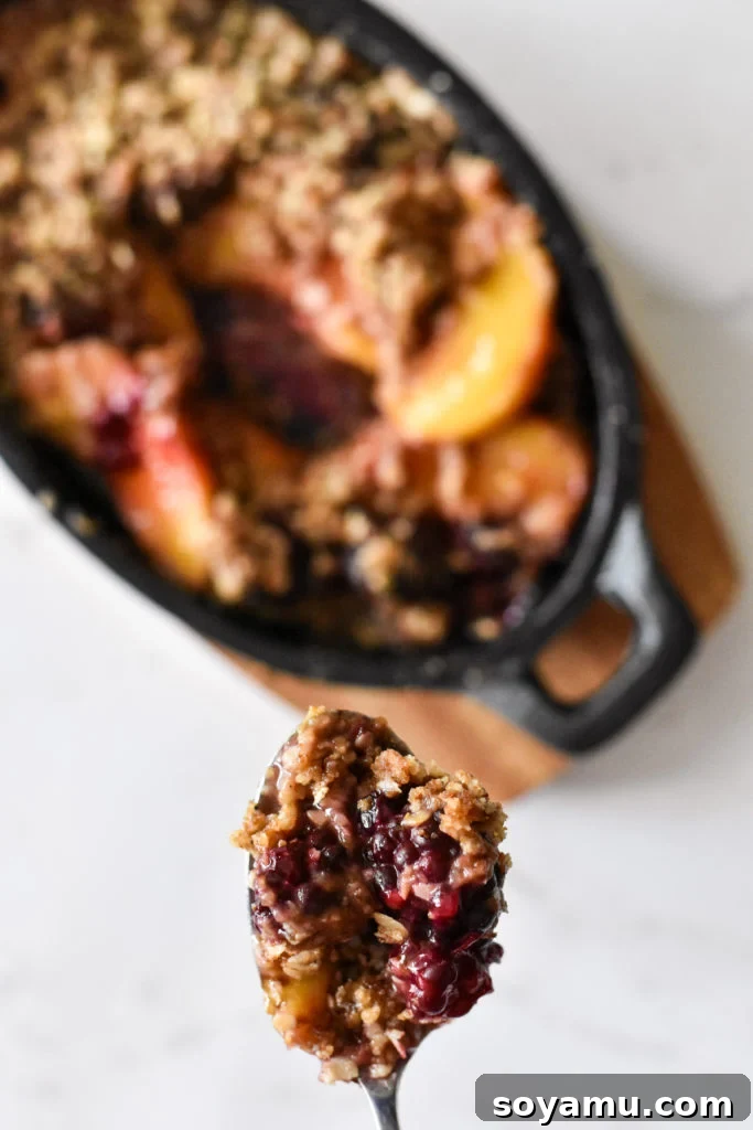 Intimate Peach Blackberry Crisp 6 A high-angle shot of the finished fruit crumble with ice cream, in the mini cast iron skillet.