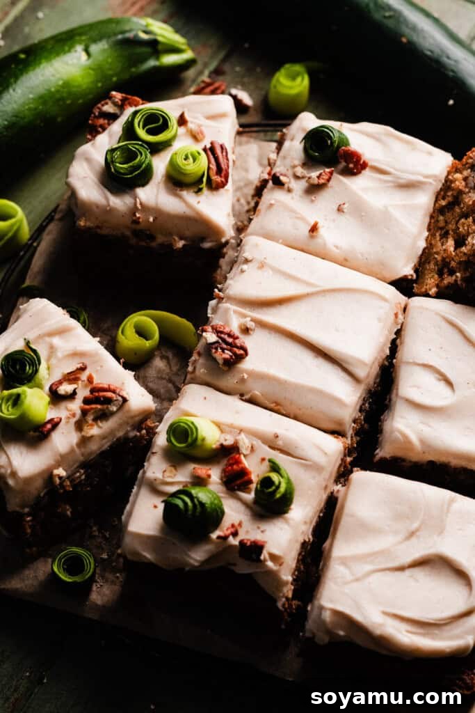 Irresistible Zucchini Snack Cake with Brown Butter Cream Cheese Frosting 2 A perfectly sliced 9-inch square zucchini cake, beautifully frosted with brown butter cream cheese frosting, resting on a vintage wire cooling rack.