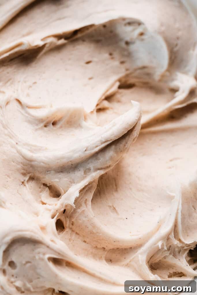 Irresistible Zucchini Snack Cake with Brown Butter Cream Cheese Frosting 7 A close-up shot of the velvety brown butter cream cheese frosting in a glass mixing bowl, perfectly creamy and ready for spreading.