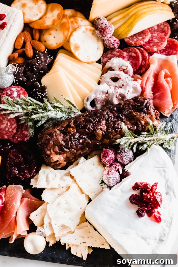 A perfectly assembled, abundant cheese and charcuterie board A completed and artfully arranged cheese and charcuterie board, ready for serving.