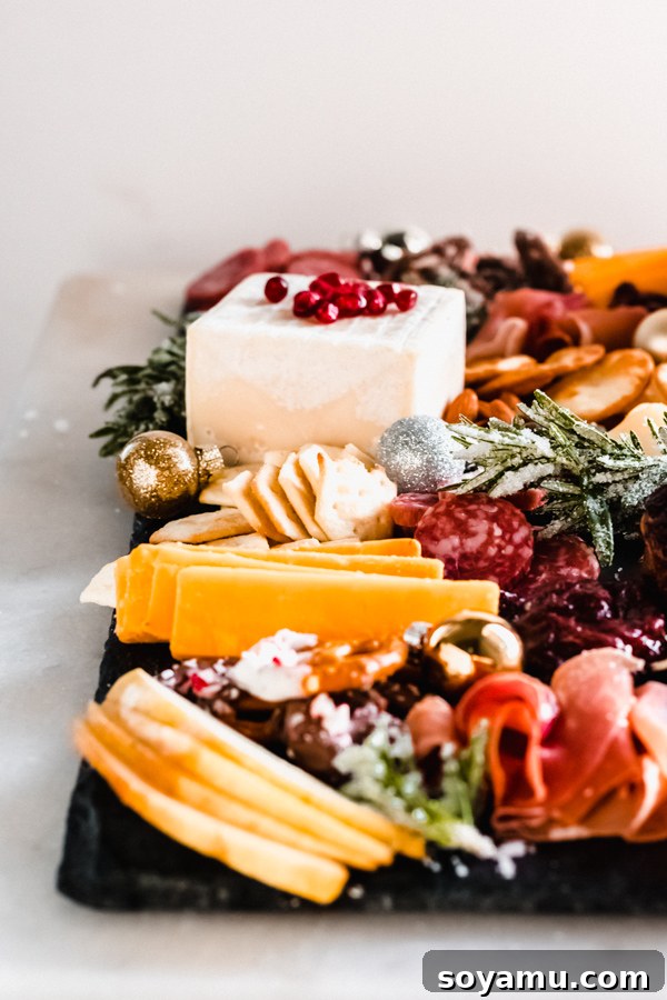 A colorful and enticing cheese board prepared for a celebration A festive cheese board brimming with an array of colorful and delicious items.