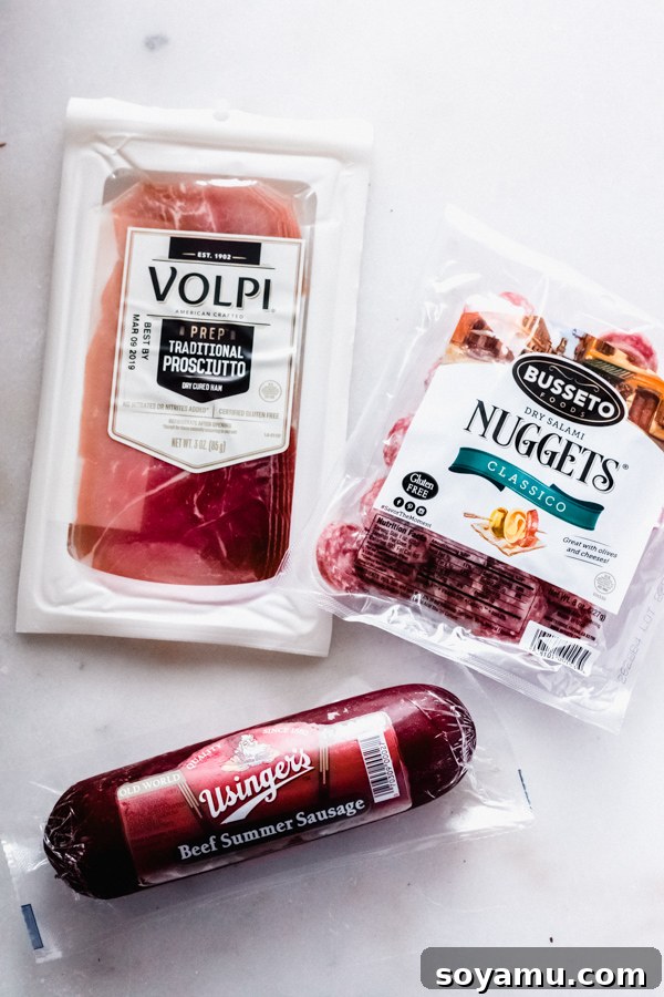 Assorted charcuterie meats ready for a platter A selection of cured meats, including salami and prosciutto, arranged for a cheese board.