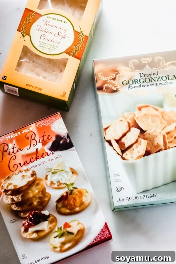 Selection of crackers to accompany a cheese and charcuterie spread Various cracker boxes on a surface, showing options for a cheese board.