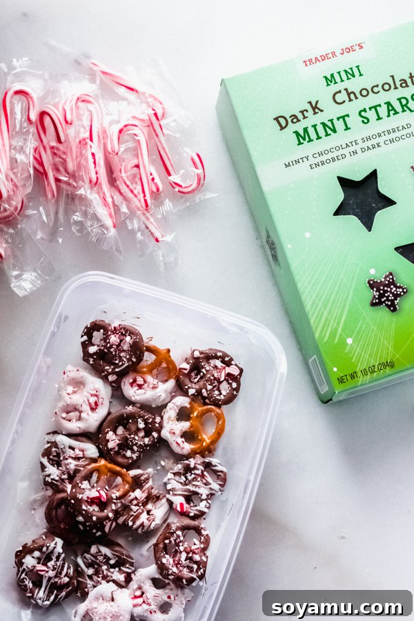 Holiday-themed chocolate covered pretzels with peppermint Chocolate covered pretzels topped with peppermint sprinkles, a sweet addition to a board.