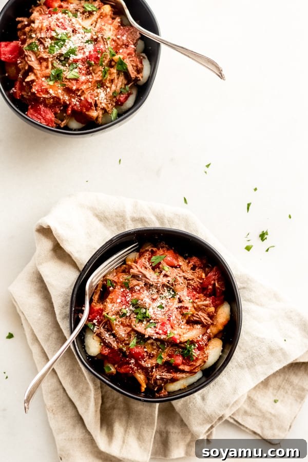 Braised Beef with Tomatoes + Gnocchi - A healthy, easy, and comforting one-pot meal perfect for any occasion. A bowl of tender braised beef with saucy tomatoes and soft gnocchi, garnished with fresh parsley.