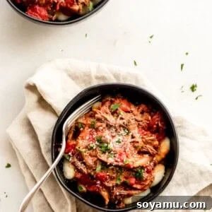 Slow-Cooked Beef Ragu with Pillowy Gnocchi 2 A dish of Braised Beef with Tomatoes and Gnocchi.