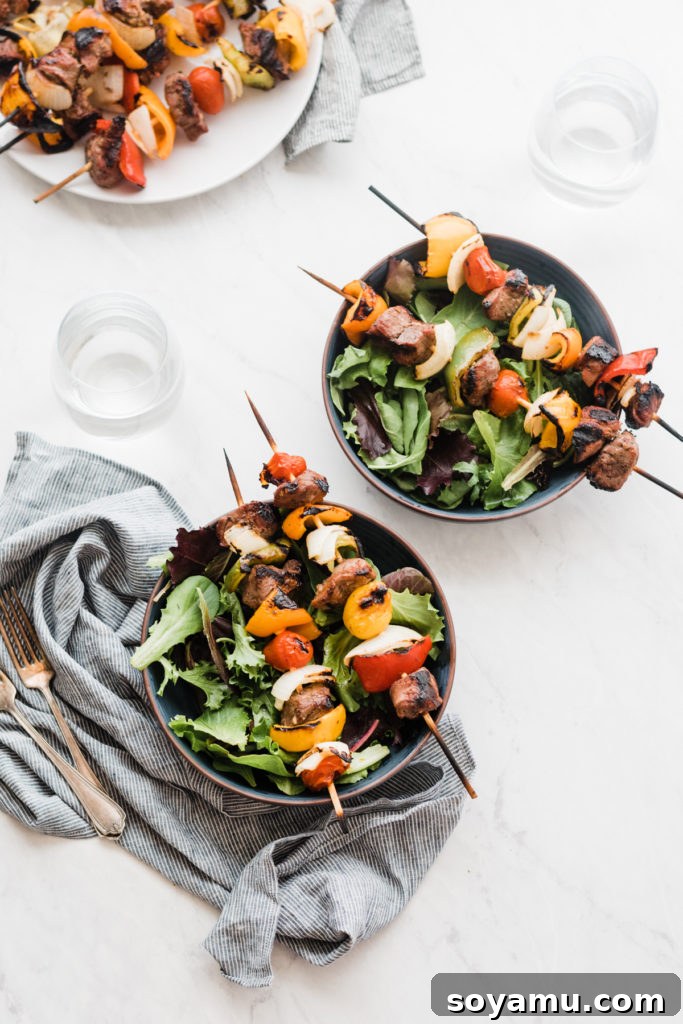 Grilled Lamb Kebabs - Easy and flavorful for grilling enthusiasts. Grilled Lamb Kebabs with colorful marinated vegetables like peppers, onions, and tomatoes, cooked to perfection.