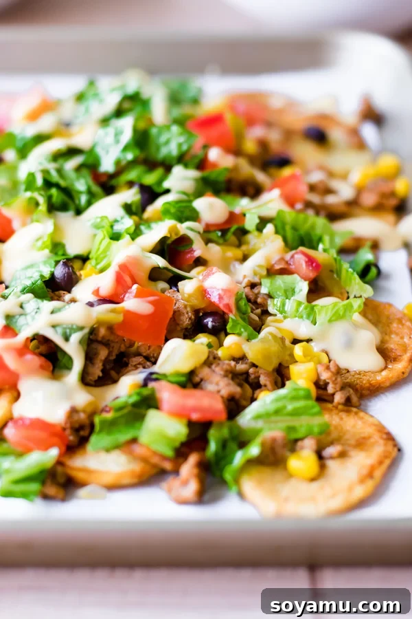 Loaded Sheet Pan Nachos - Fun, customizable, and Whole30 compliant. Loaded Sheet Pan Nachos made with homemade potato chips and abundant toppings, perfect for a customizable snack or meal.