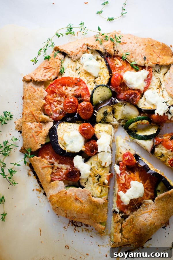Mixed Vegetable Galette - Balanced meal with roasted veggies and cheese. A rustic Mixed Vegetable Galette, showcasing an array of roasted vegetables and cheese nestled in a flaky pie crust.