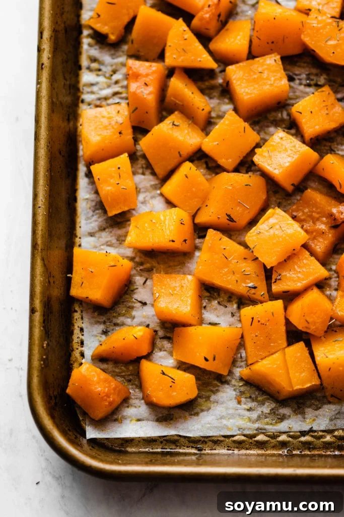 Easy Roasted Butternut Squash - Simple and healthy vegetable side. Cubed Easy Roasted Butternut Squash, perfectly roasted to a golden brown and seasoned with herbs.