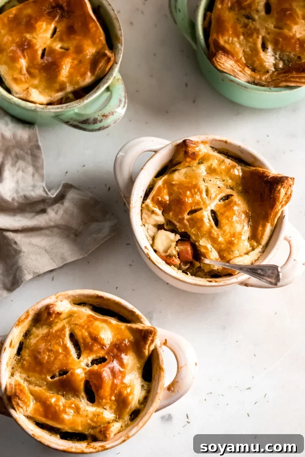 Cozy Chicken Pot Pie A golden-brown chicken pot pie, baked to perfection in a ceramic dish, with flaky puff pastry topping.