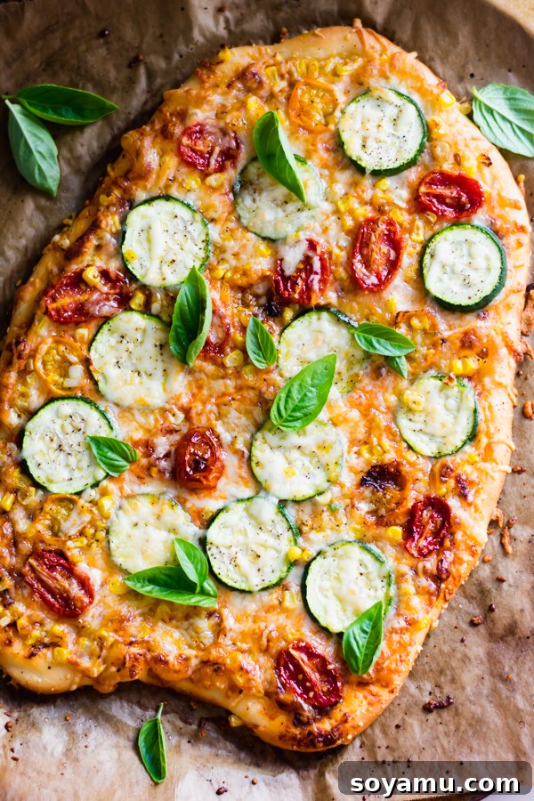 Roasted Tomato, Corn, and Zucchini Flatbread Pizza Crispy roasted tomato, corn, and zucchini flatbread pizza topped with fresh basil.