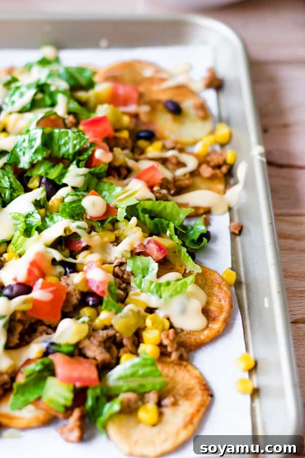 Loaded Sheet Pan Nachos for Two Generously loaded sheet pan nachos with melted cheese, jalapeños, and other toppings, perfect for sharing.