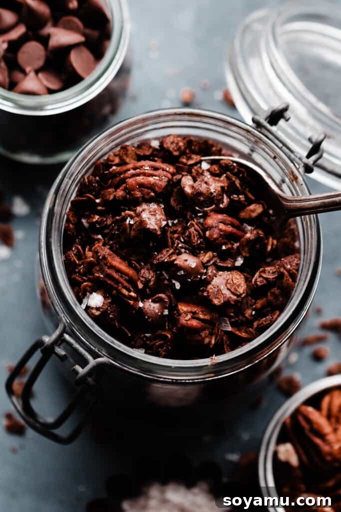 A beautiful glass jar filled to the brim with homemade chocolate granola, ready for storage or serving.