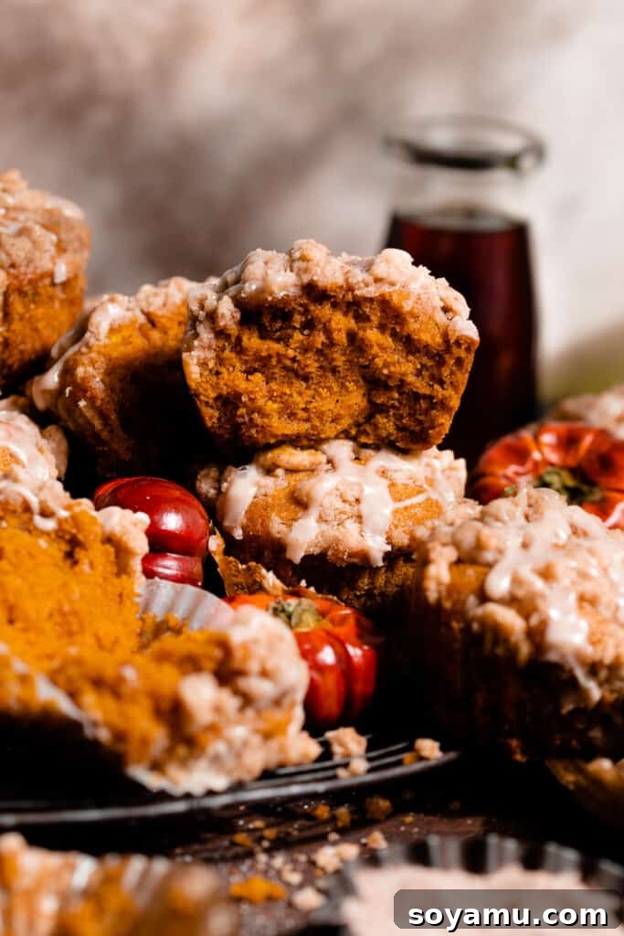 Maple-Drizzled Pumpkin Crumble Muffins 13 A stack of pumpkin muffins on a vintage wire rack.