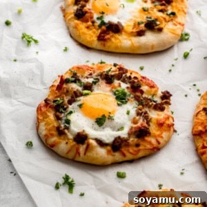 A photo of the breakfast pizzas on parchment paper, ready to be served.
