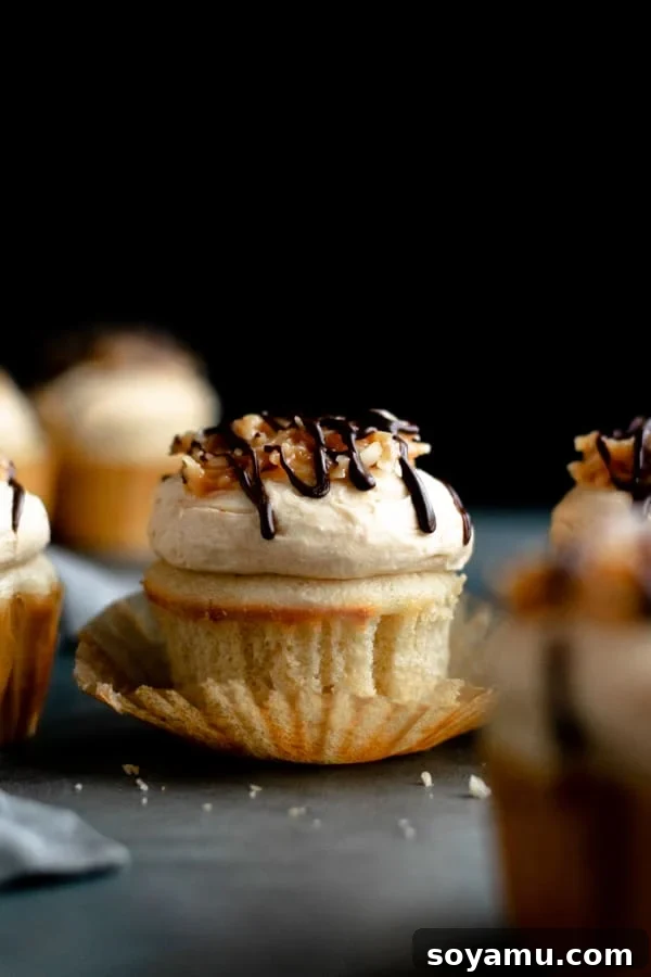 Delicious Samoa cupcakes on a black board, showing rich caramel, coconut, and chocolate toppings.