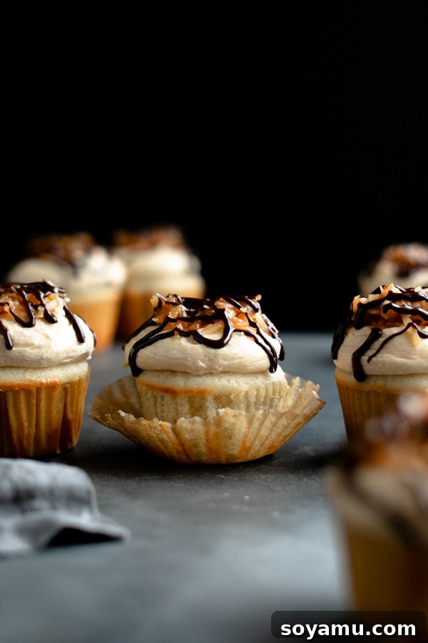 Several Samoa cupcakes displayed artfully on a black board, ready to be devoured.