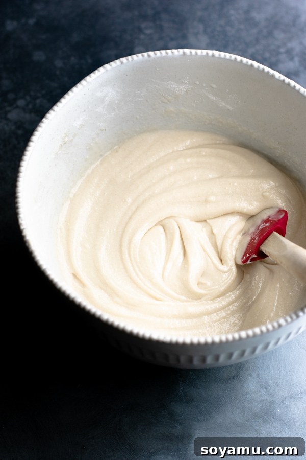 A closer look at the cupcake batter in the bowl, highlighting its smooth, yet slightly lumpy texture.