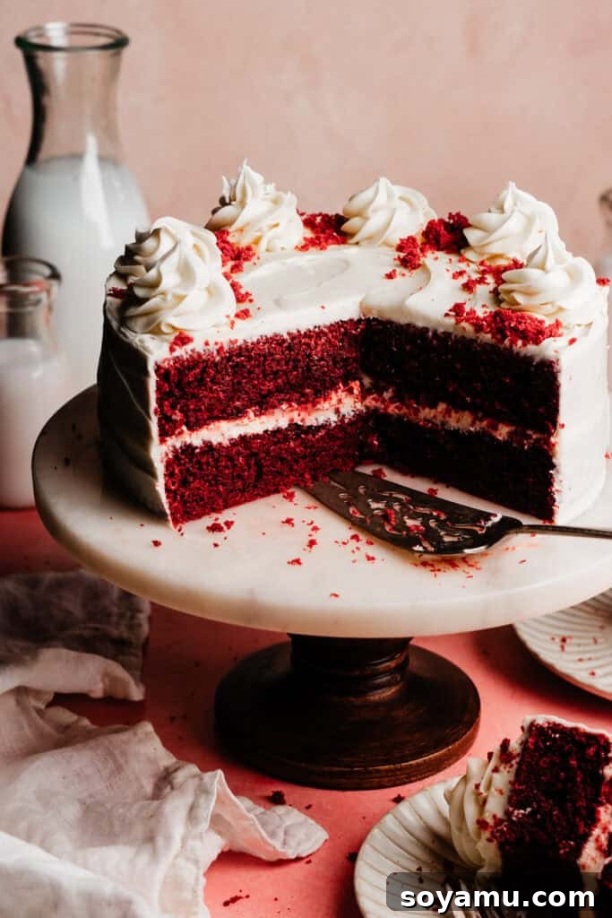 Decadent Red Velvet Dream 14 The sliced red velvet cake presented elegantly on a cake stand, ready to be enjoyed.