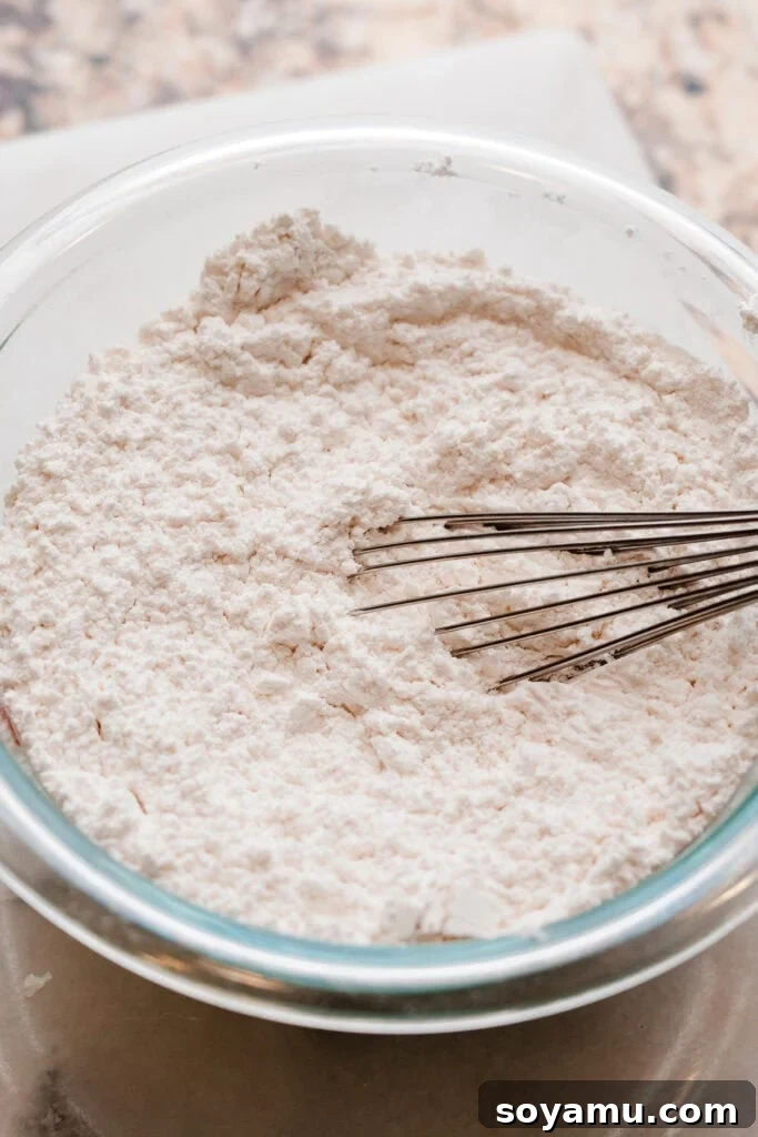 Decadent Red Velvet Dream 5 A bowl of the dry ingredients, including cake flour, baking soda, and salt, whisked together for the red velvet cake.