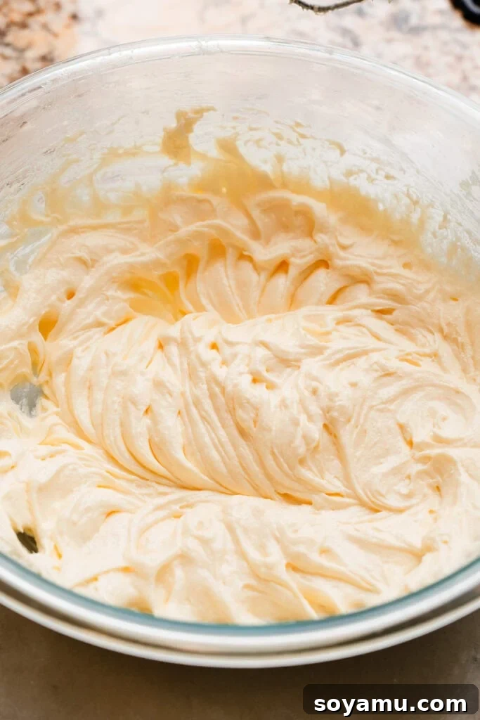Decadent Red Velvet Dream 6 The fluffy, thick, and pale mixture you'll have after mixing the eggs into the butter and sugar, indicating proper aeration.