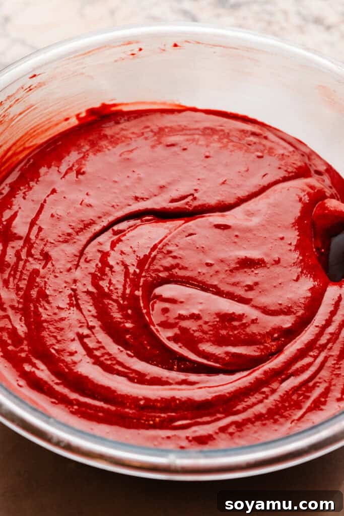 Decadent Red Velvet Dream 7 A bowl of the deep red cake batter, perfectly mixed and ready for baking.