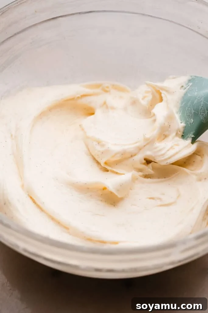 Silky Cream Cheese Frosting Perfection 3 A mixing bowl filled with freshly made, fluffy cream cheese frosting, highlighting its smooth and inviting texture against a clean backdrop.