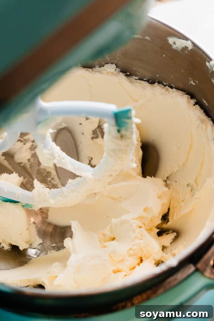 Silky Cream Cheese Frosting Perfection 5 Butter and cream cheese perfectly mixed together to a smooth, uniform consistency in the bowl of a stand mixer, ready for powdered sugar.