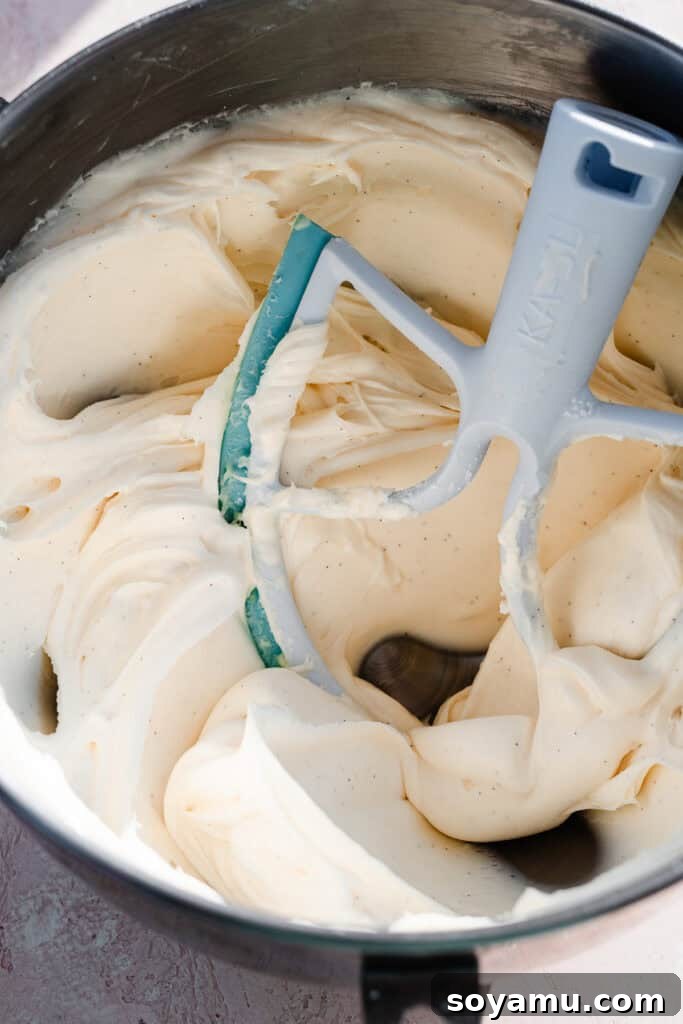 Silky Cream Cheese Frosting Perfection 7 A large bowl of super silky, luscious cream cheese frosting, smooth and inviting, signifying readiness for use.