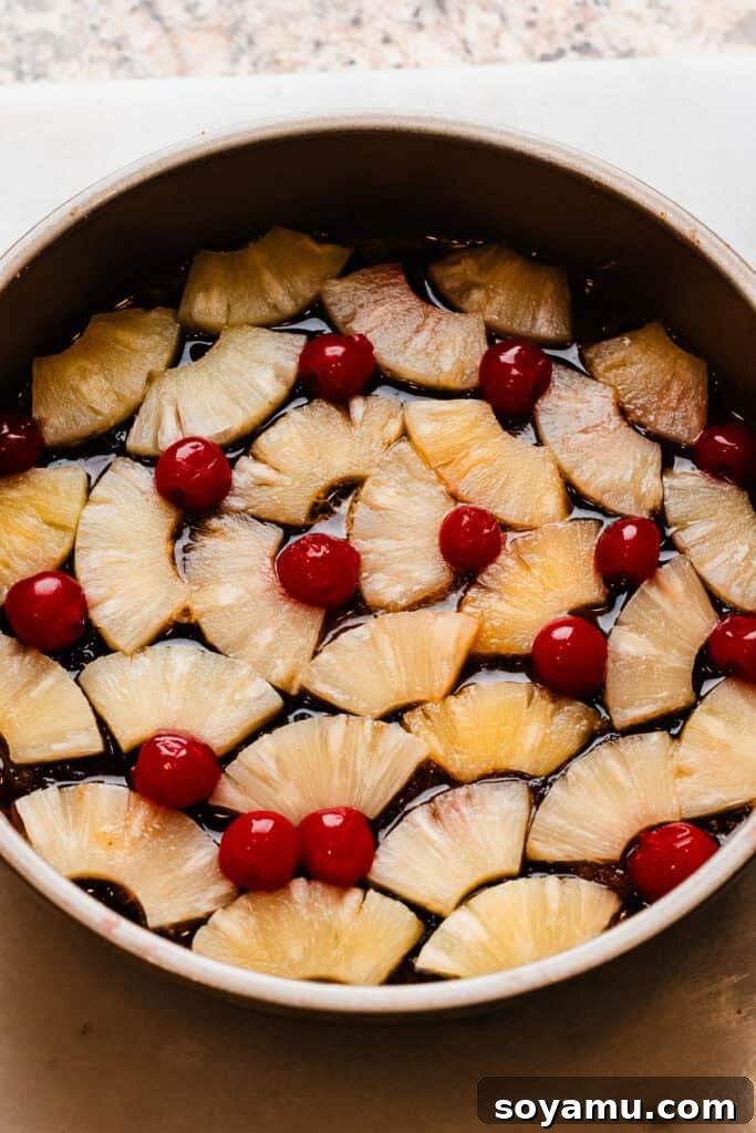 Caramelized Pineapple Dream 6 Pineapple slices and maraschino cherries layered in the cake pan, over the brown sugar and butter.