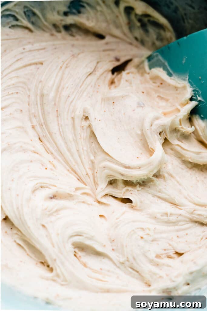Brown Butter Cream Cheese Frosted Carrot Cupcakes 9 A bowl filled with lusciously creamy white brown butter cream cheese frosting, expertly smoothed with an offset spatula, ready to be piped.
