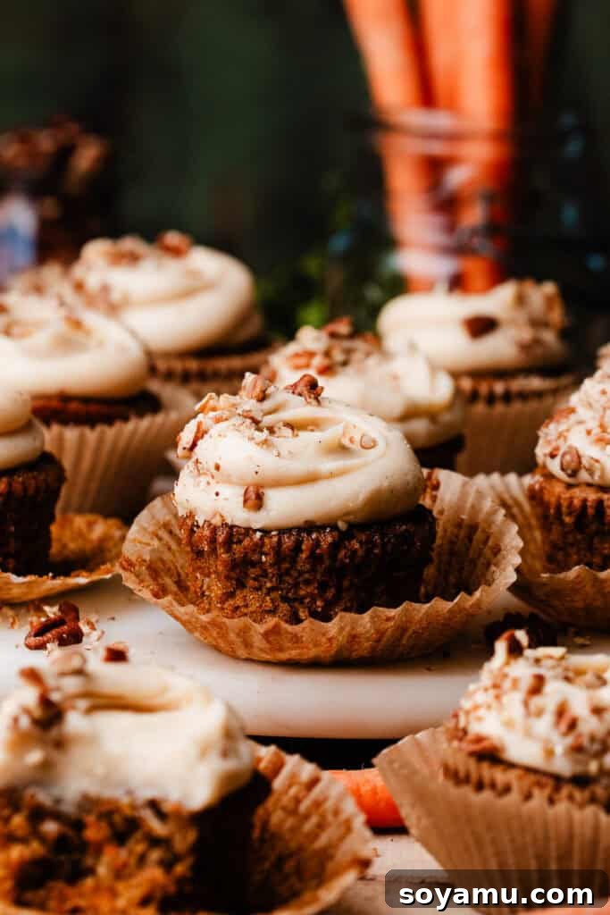 Brown Butter Cream Cheese Frosted Carrot Cupcakes 10 Beautifully frosted carrot cake cupcakes arranged on a sophisticated marble plate, ready to be enjoyed.