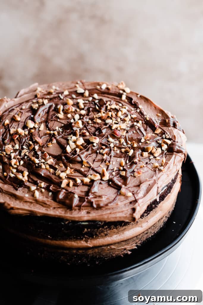 Velvety Nutella Frosting 7 Layers of decadent chocolate cake being expertly frosted with luscious Nutella frosting using a spatula.