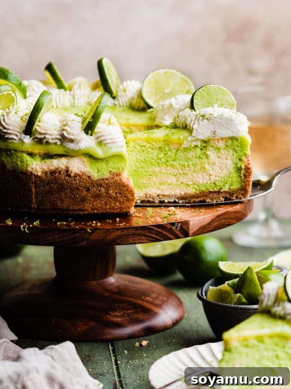 Ultra-Creamy Key Lime Pie Recipe for Perfectly Tangy Slices 16 The sliced key lime cheesecake on a cake stand.