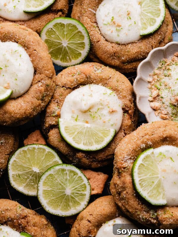 Ultra-Creamy Key Lime Pie Recipe for Perfectly Tangy Slices 17 A close-up of the key lime pie cookies nestled together on a cooling rack, with slices of lime for garnish.