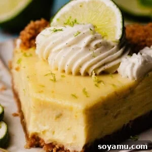 Ultra-Creamy Key Lime Pie Recipe for Perfectly Tangy Slices 19 A close-up of a slice of key lime pie on a dessert plate, with a bite missing.