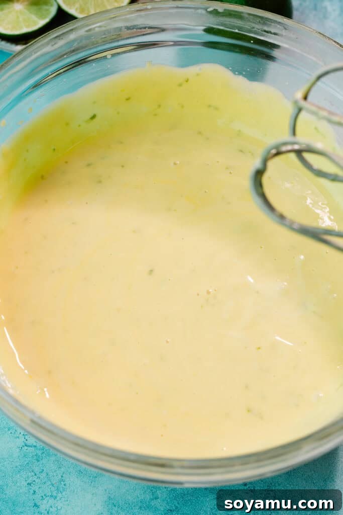Ultra-Creamy Key Lime Pie Recipe for Perfectly Tangy Slices 8 The finished key lime pie filling. It's thick but not super thick, with a yellowish tint.