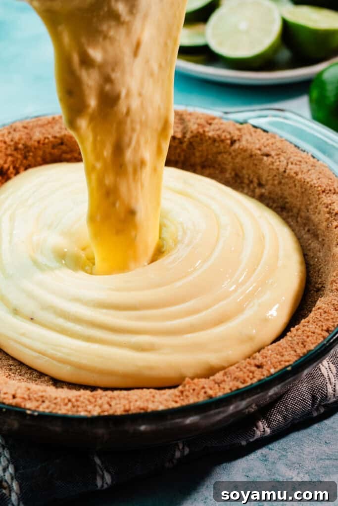 Ultra-Creamy Key Lime Pie Recipe for Perfectly Tangy Slices 9 The filling being poured into the baked crust.