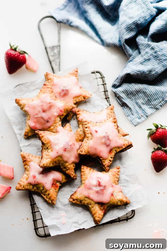 Strawberry Rhubarb Hand Pies Star shaped hand pies on grate with strawberries
