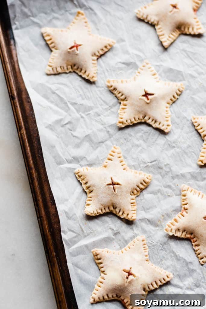 Strawberry Rhubarb Hand Pies Unbaked star shaped hand pies on baking sheet