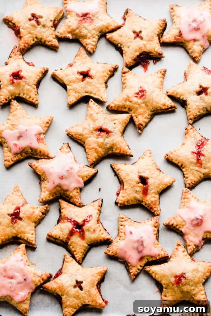 Strawberry Rhubarb Hand Pies Freshly baked star shaped hand pies on tray with glaze