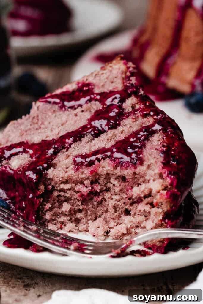 Double Blueberry Bundt Cake Recipe for Moist, Fruity Treat 15 A close-up on a slice of the cake, with a bite missing, to show the fluffy texture.